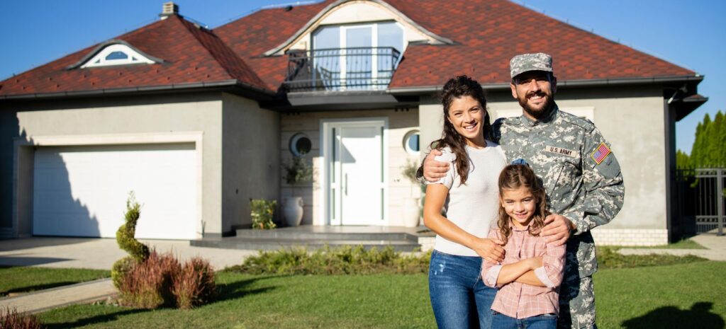 Veteran with his family in front of their home with a white garage door