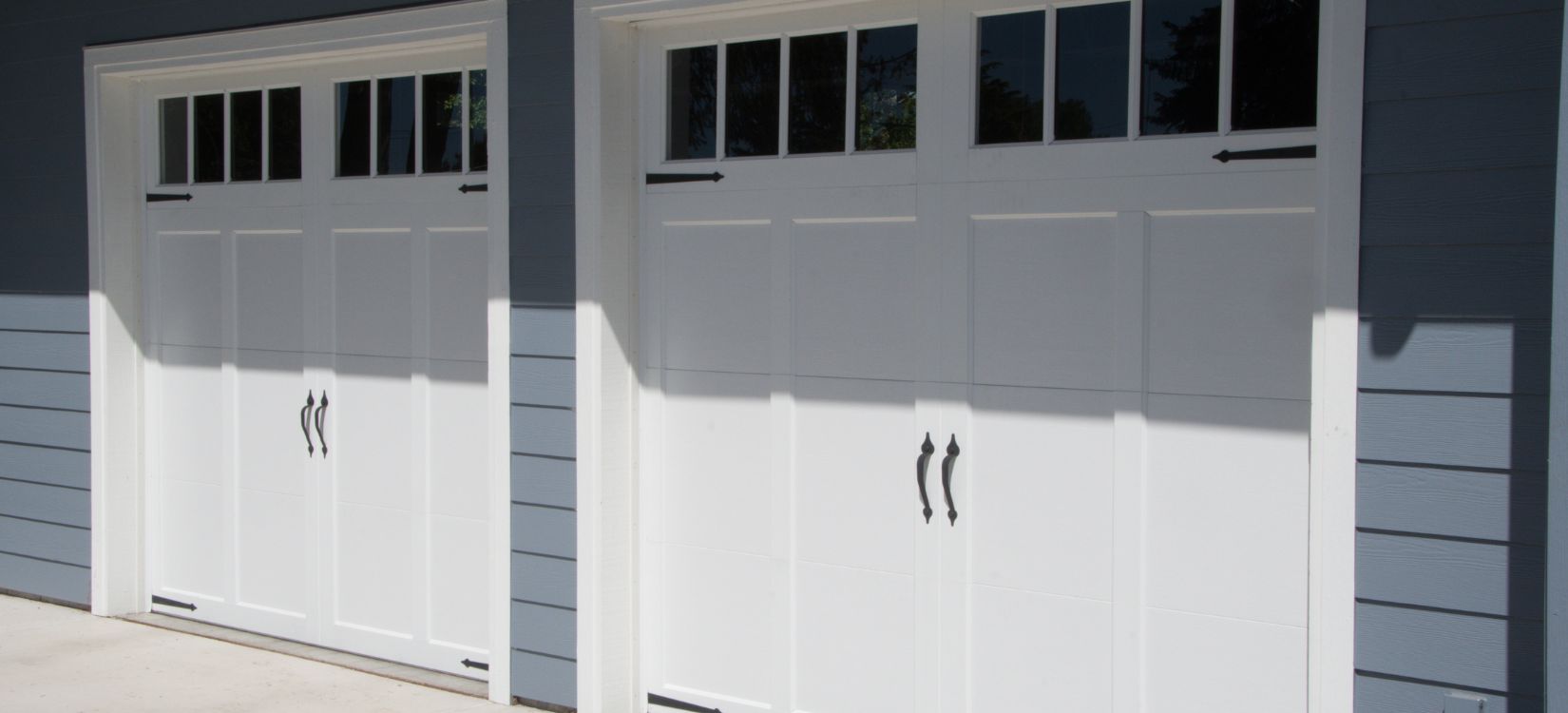 Two white carriage style garage doors