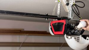 Technician performing routine garage door maintenance