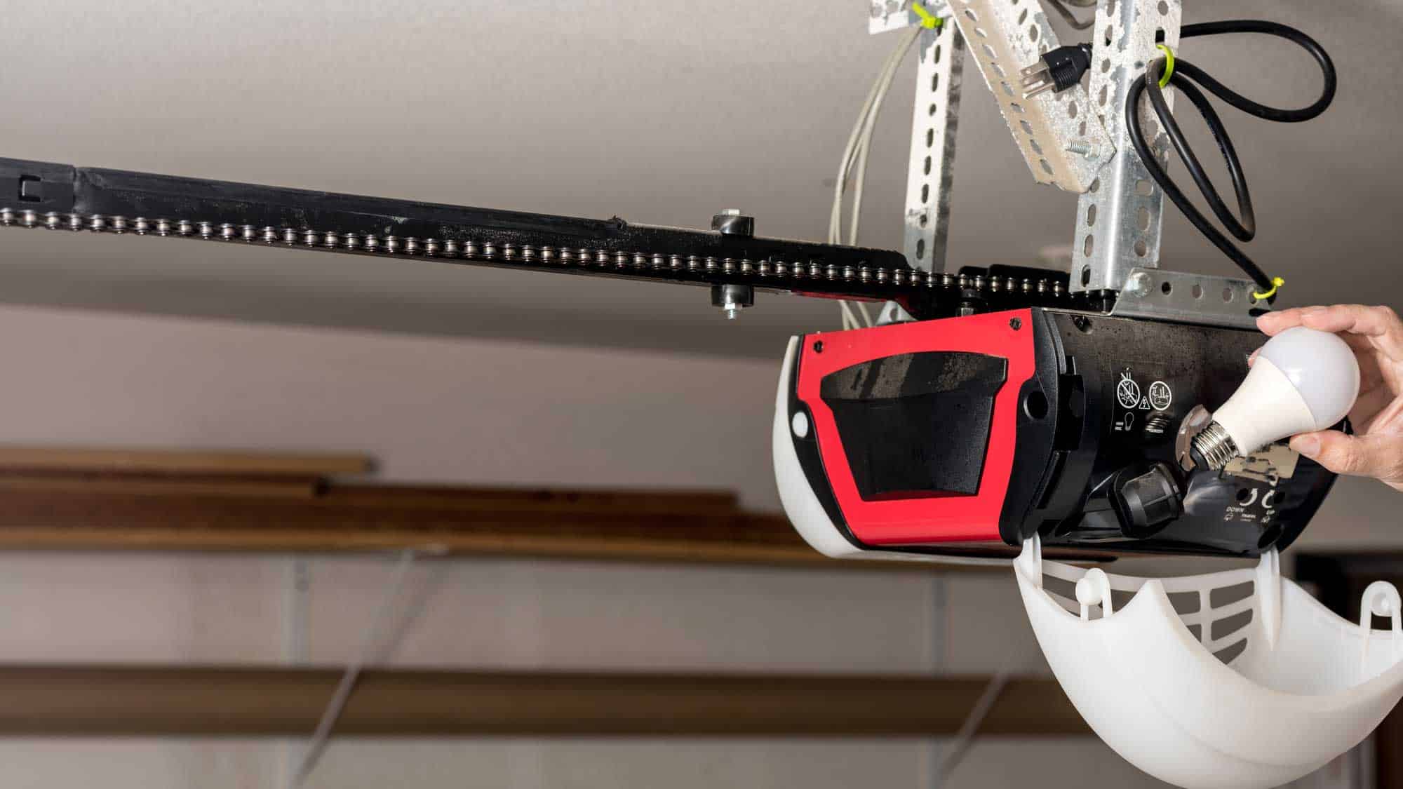 Technician performing routine garage door maintenance