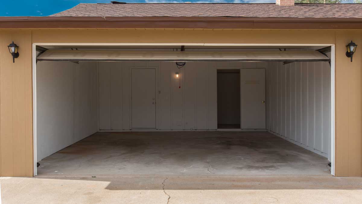 Open residential garage with white panel door